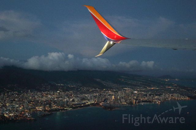 Boeing 737-700 — - Very first day of Southwest Airlines operating in Hawaii. Flying from Honolulu to Maui. Passing by Waikiki beach below. Told the pilot navigation was super easy in the islands. Just look for a runway on the second island east of Oahu and you're there. Questions about this photo can be sent to Info@FlewShots.com