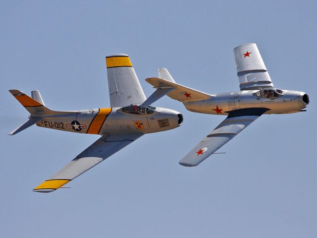 — — - F-86 Sabre vs MiG-15 Fagot. In the 1950s - during the Korean War - American F-86 Sabres were fighting against Soviet-made MiG-15. I photographed this mock dogfight at the Airshow in Chino, California in May 2009.
